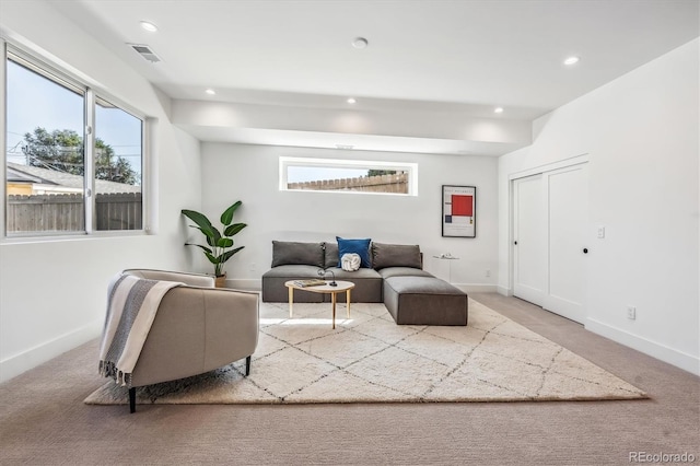 living room featuring carpet floors, baseboards, recessed lighting, and visible vents