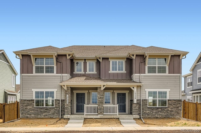 15228 Detroit St, Thornton, CO 80602 - view of front of home featuring covered porch, stone siding, and board and batten siding