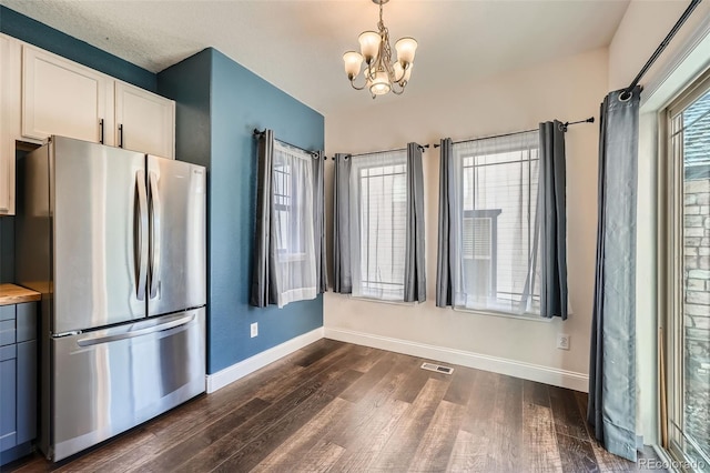 5624 Killdeer St, Brighton, CO 80601 - kitchen featuring freestanding refrigerator, dark wood-style flooring, baseboards, and a chandelier