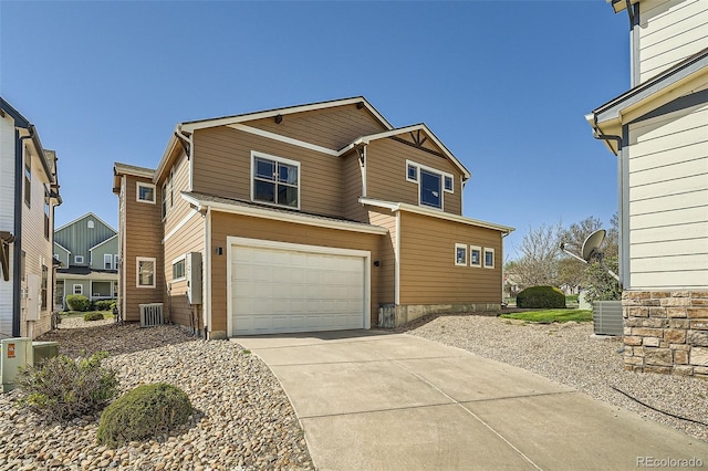 5624 Killdeer St, Brighton, CO 80601 - view of front of house featuring a garage, cooling unit, and driveway
