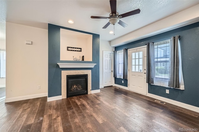 5624 Killdeer St, Brighton, CO 80601 - unfurnished living room with baseboards, wood finished floors, a tile fireplace, and recessed lighting