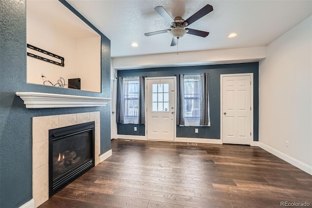 5624 Killdeer St, Brighton, CO 80601 - unfurnished living room featuring hardwood / wood-style flooring, baseboards, a fireplace, recessed lighting, and ceiling fan