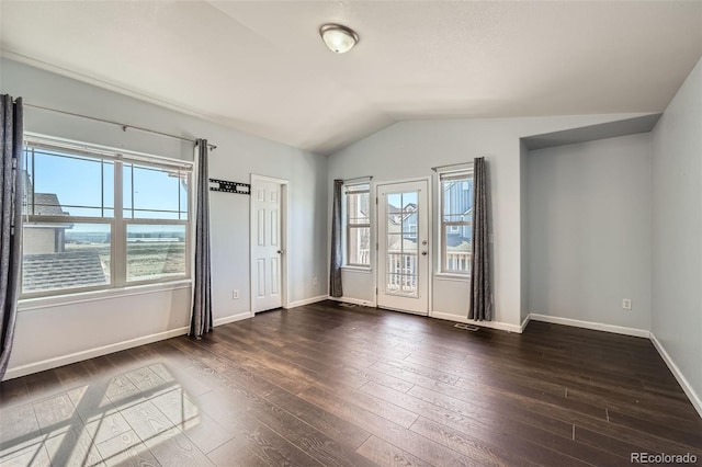5624 Killdeer St, Brighton, CO 80601 - spare room featuring dark wood-style flooring, vaulted ceiling, and baseboards