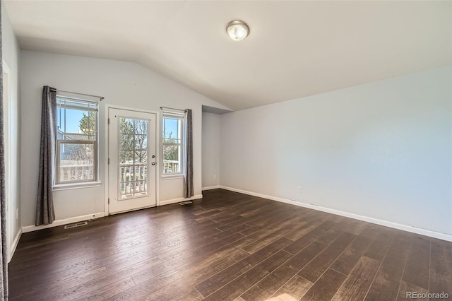 5624 Killdeer St, Brighton, CO 80601 - spare room featuring lofted ceiling, dark wood-type flooring, and baseboards