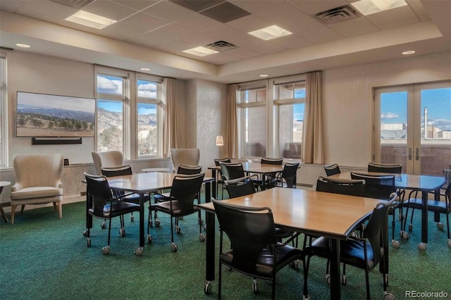 carpeted dining room with a raised ceiling, french doors, visible vents, and a paneled ceiling