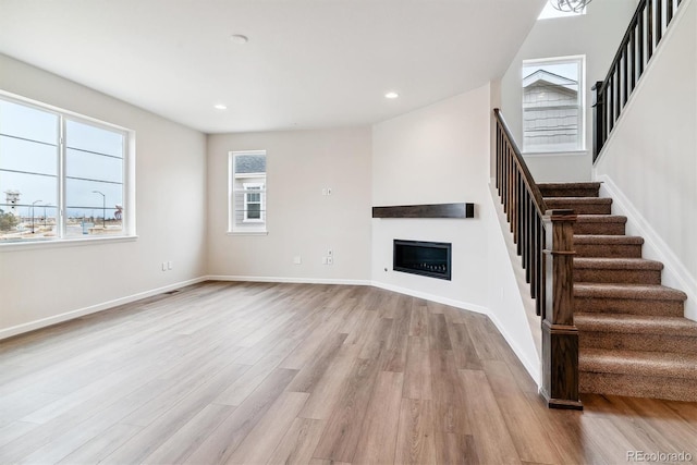 unfurnished living room with light wood-type flooring