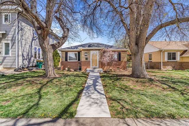 view of front of home with brick siding and a front lawn