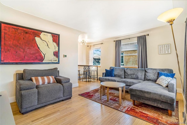living area with baseboards and hardwood / wood-style floors