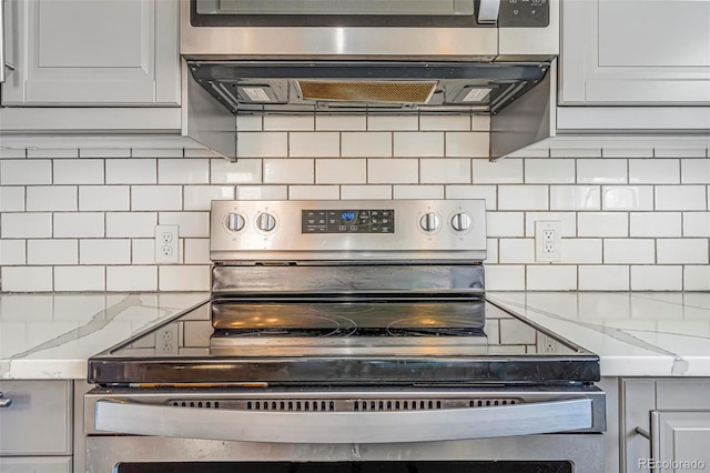 room details featuring appliances with stainless steel finishes and decorative backsplash