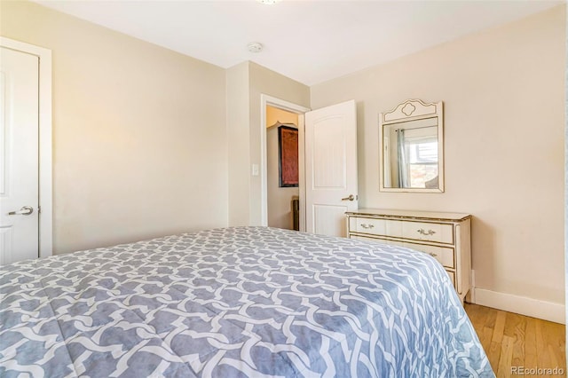 bedroom with baseboards and light wood-style flooring