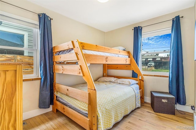 bedroom featuring baseboards and hardwood / wood-style floors