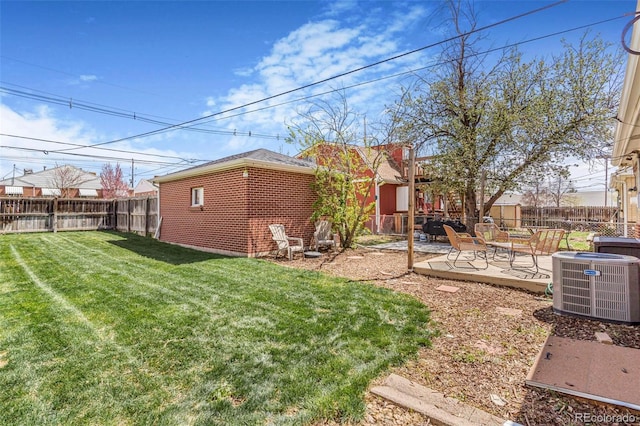 view of yard featuring a fenced backyard, a patio, an outdoor structure, and cooling unit
