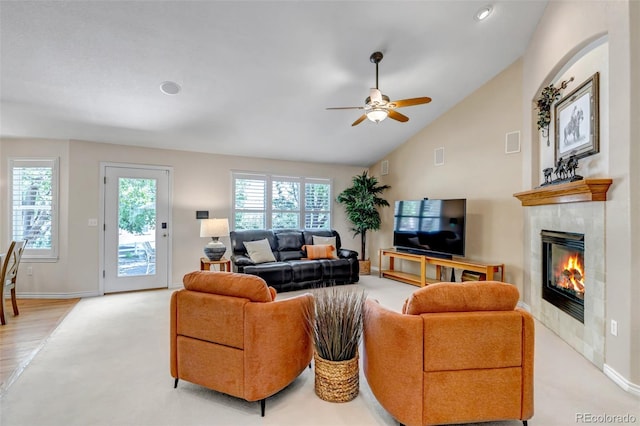 6633 E 166th Pl, Brighton, CO 80602 - living room featuring a fireplace, a ceiling fan, lofted ceiling, baseboards, and light colored carpet