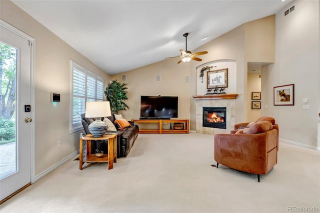 6633 E 166th Pl, Brighton, CO 80602 - carpeted living area featuring vaulted ceiling, a tiled fireplace, baseboards, plenty of natural light, and ceiling fan