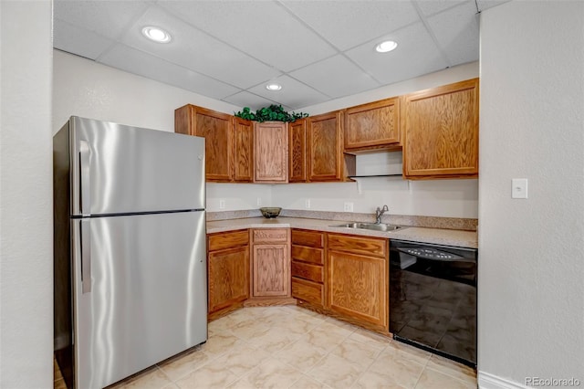 6633 E 166th Pl, Brighton, CO 80602 - kitchen with freestanding refrigerator, dishwasher, a sink, light countertops, and a paneled ceiling