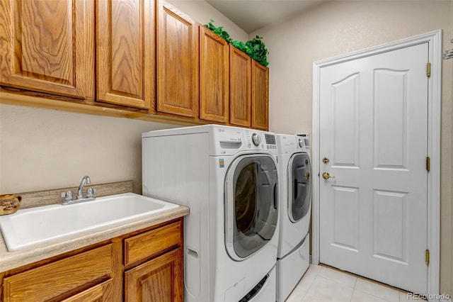 6633 E 166th Pl, Brighton, CO 80602 - laundry area with washer and dryer, cabinet space, and light tile patterned flooring