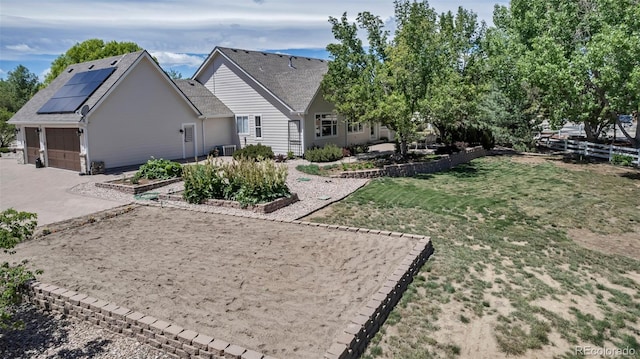 6633 E 166th Pl, Brighton, CO 80602 - back of property featuring solar panels, driveway, and central AC