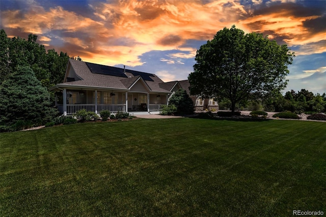 6633 E 166th Pl, Brighton, CO 80602 - farmhouse with roof mounted solar panels, a lawn, and covered porch