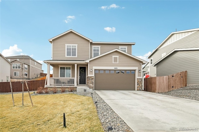 view of front of house with a garage, fence, covered porch, and driveway