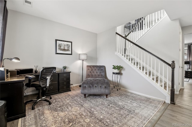 office with visible vents, baseboards, and wood finished floors