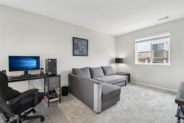 living area with visible vents, baseboards, and carpet