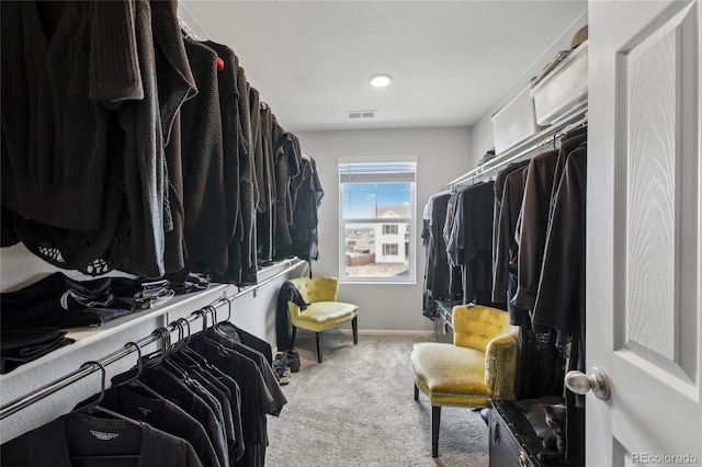 walk in closet featuring visible vents and carpet