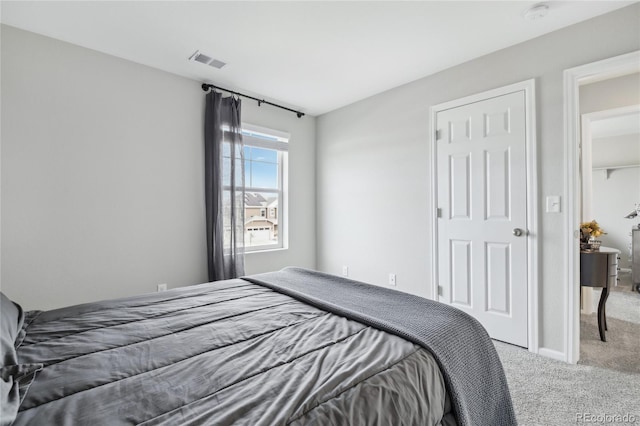 bedroom featuring visible vents and light carpet