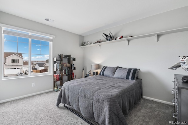 carpeted bedroom featuring visible vents and baseboards