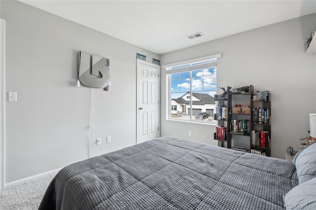 bedroom with visible vents, baseboards, and carpet