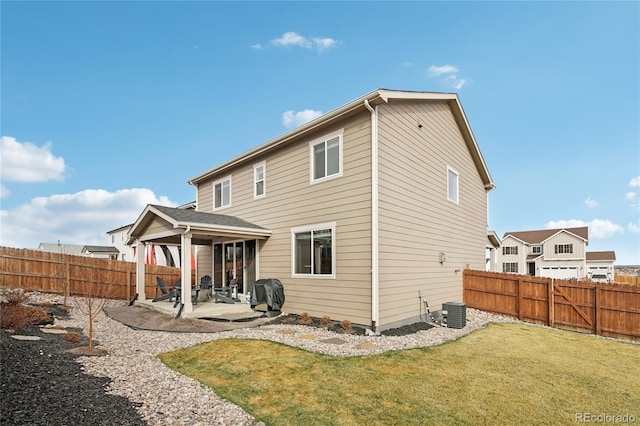 back of property featuring cooling unit, a yard, a fenced backyard, and a patio area