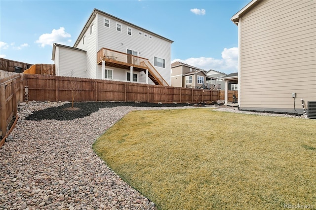 view of yard with central AC and a fenced backyard