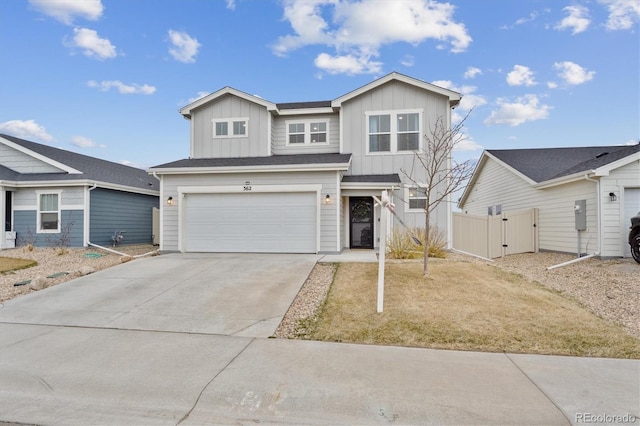 362 Bozeman Trl, Ault, CO 80610 - traditional-style home with board and batten siding, a garage, a gate, concrete driveway, and fence