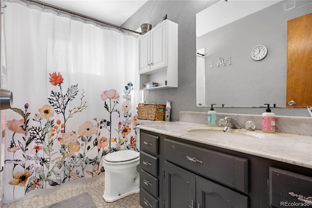 bathroom with vanity, toilet, and walk in shower