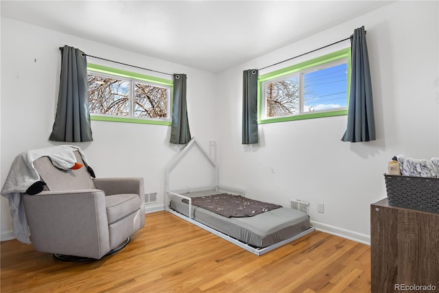 sitting room with hardwood / wood-style floors and a wealth of natural light