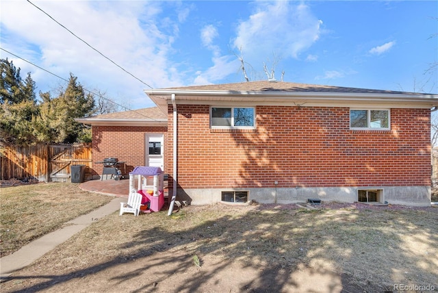 back of property with a patio and a lawn