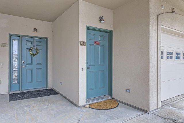 property entrance with stucco siding