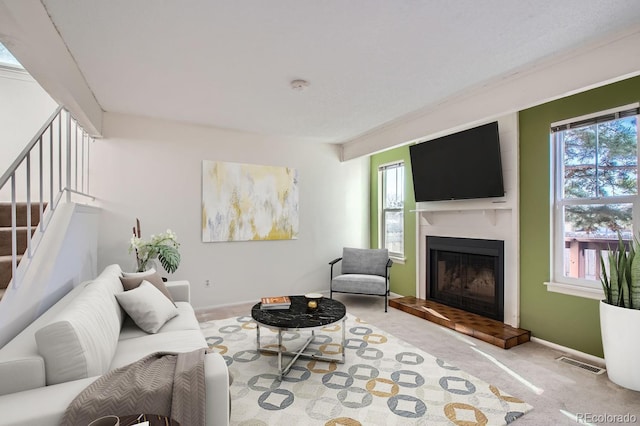 carpeted living room featuring a fireplace