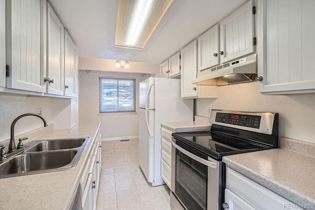 kitchen with stainless steel range with electric stovetop, sink, light tile patterned floors, and white cabinets