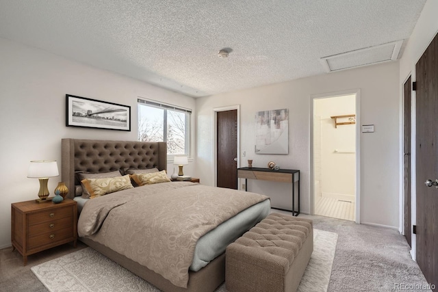 bedroom with light carpet, connected bathroom, and a textured ceiling