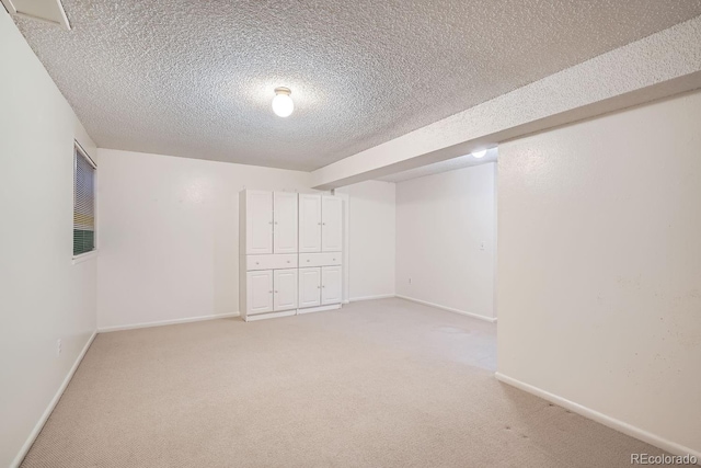 basement featuring carpet and a textured ceiling