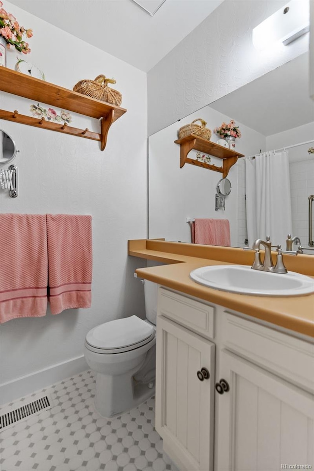 bathroom featuring vanity, a shower with curtain, and toilet