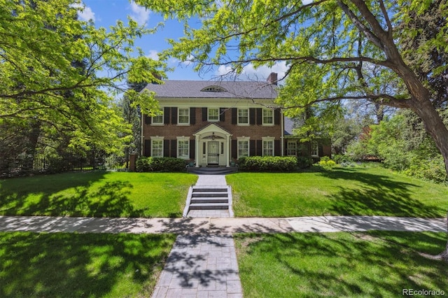 2222 E 7th Avenue Parkway, Denver, CO 80206 - view of front of home with a front yard, a chimney, and brick siding