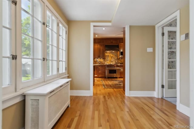 2222 E 7th Avenue Parkway, Denver, CO 80206 - corridor with light wood-style flooring, baseboards, radiator heating unit, and recessed lighting
