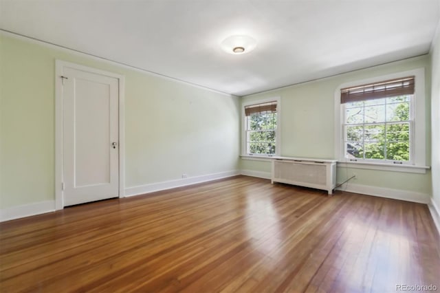 2222 E 7th Avenue Parkway, Denver, CO 80206 - unfurnished room with radiator, wood finished floors, and baseboards