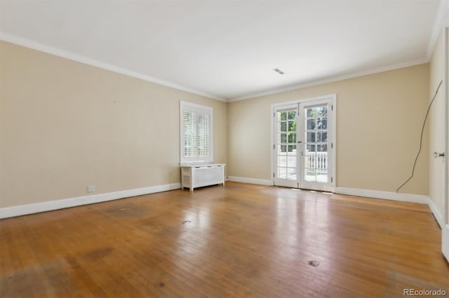 2222 E 7th Avenue Parkway, Denver, CO 80206 - empty room featuring wood finished floors, crown molding, and baseboards