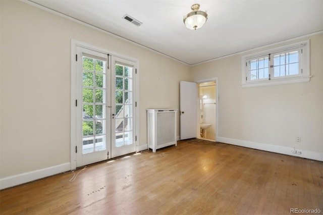 2222 E 7th Avenue Parkway, Denver, CO 80206 - empty room featuring radiator heating unit, light wood-type flooring, plenty of natural light, and ornamental molding