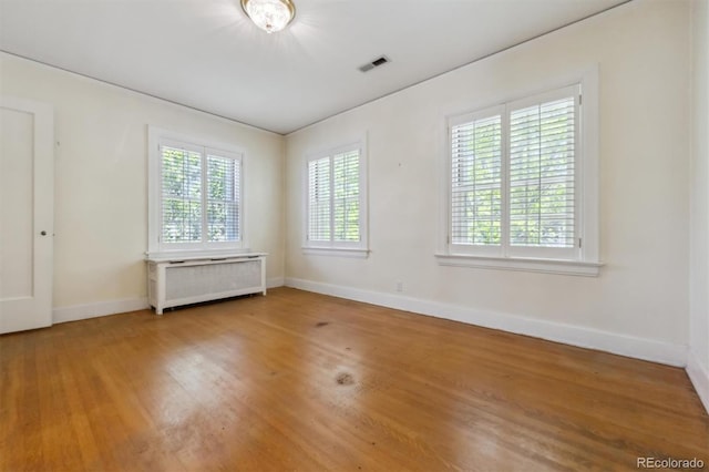 2222 E 7th Avenue Parkway, Denver, CO 80206 - spare room with baseboards, wood finished floors, and radiator