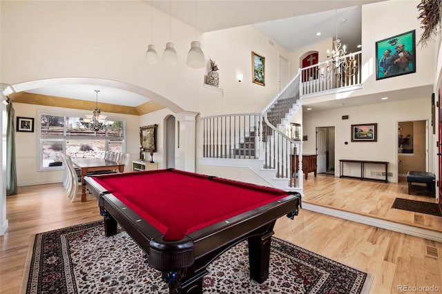 game room with a notable chandelier and wood finished floors