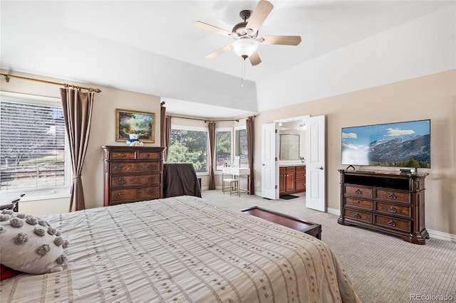 bedroom with baseboards, lofted ceiling, carpet flooring, ensuite bath, and a ceiling fan