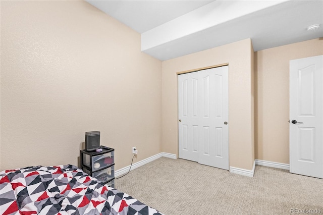 unfurnished bedroom featuring a closet, baseboards, and carpet flooring